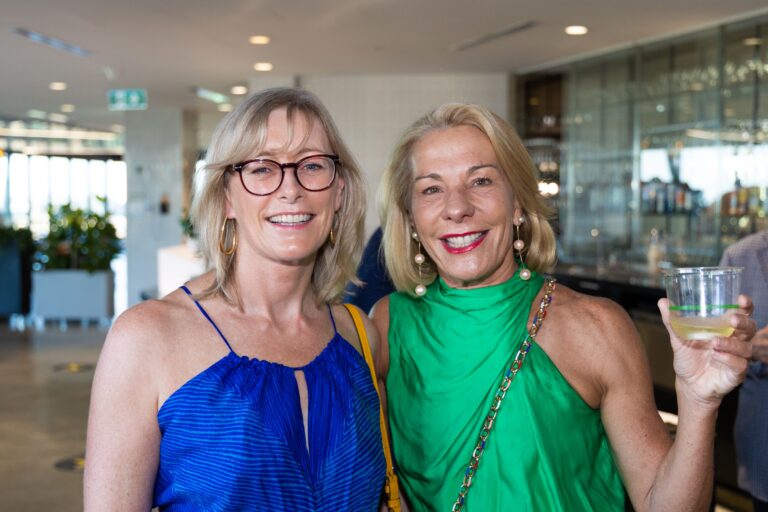 An image of two people smiling at the camera, at a fundraising event.