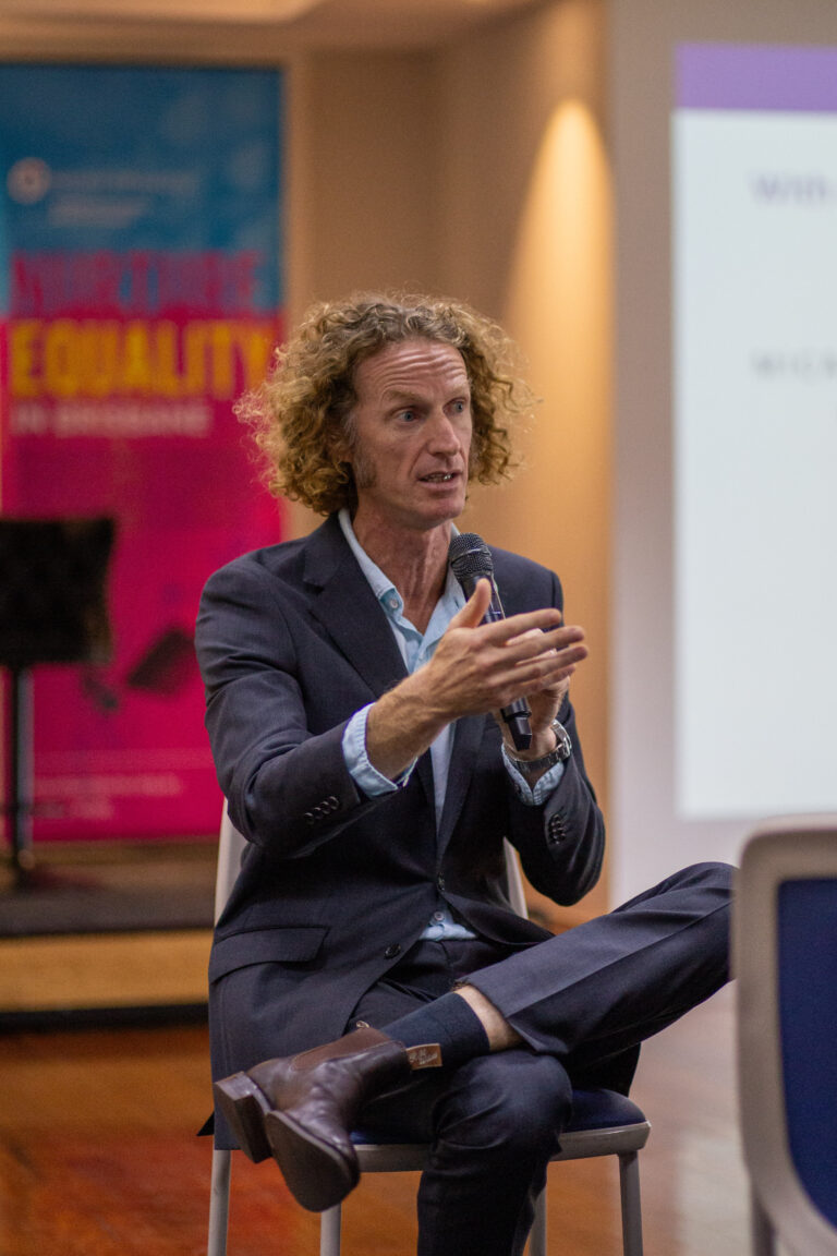 A photo of Cameron Parsell speaking at an event.