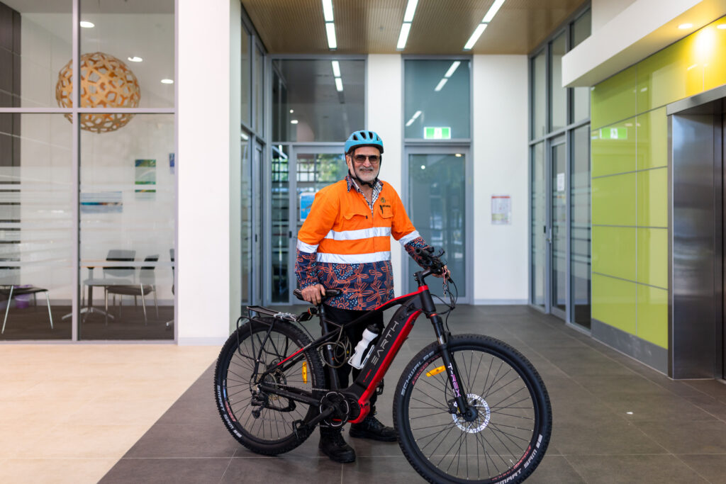 A photo of a man with a bicycle.