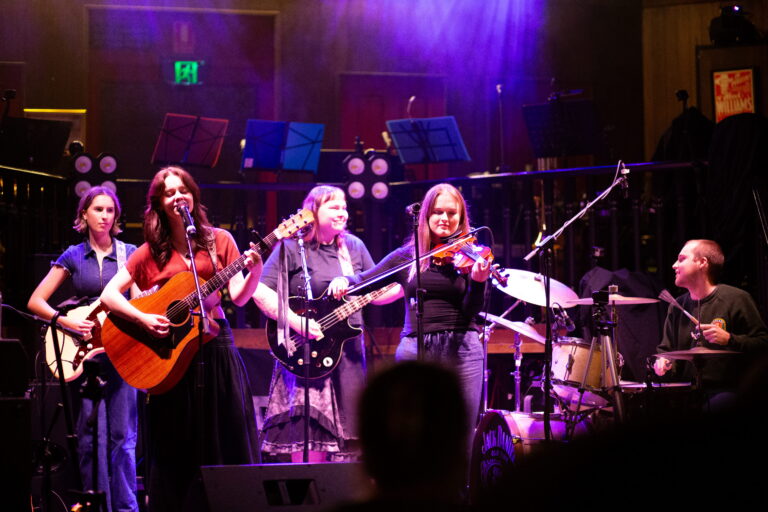 An image of a band playing in a concert venue.